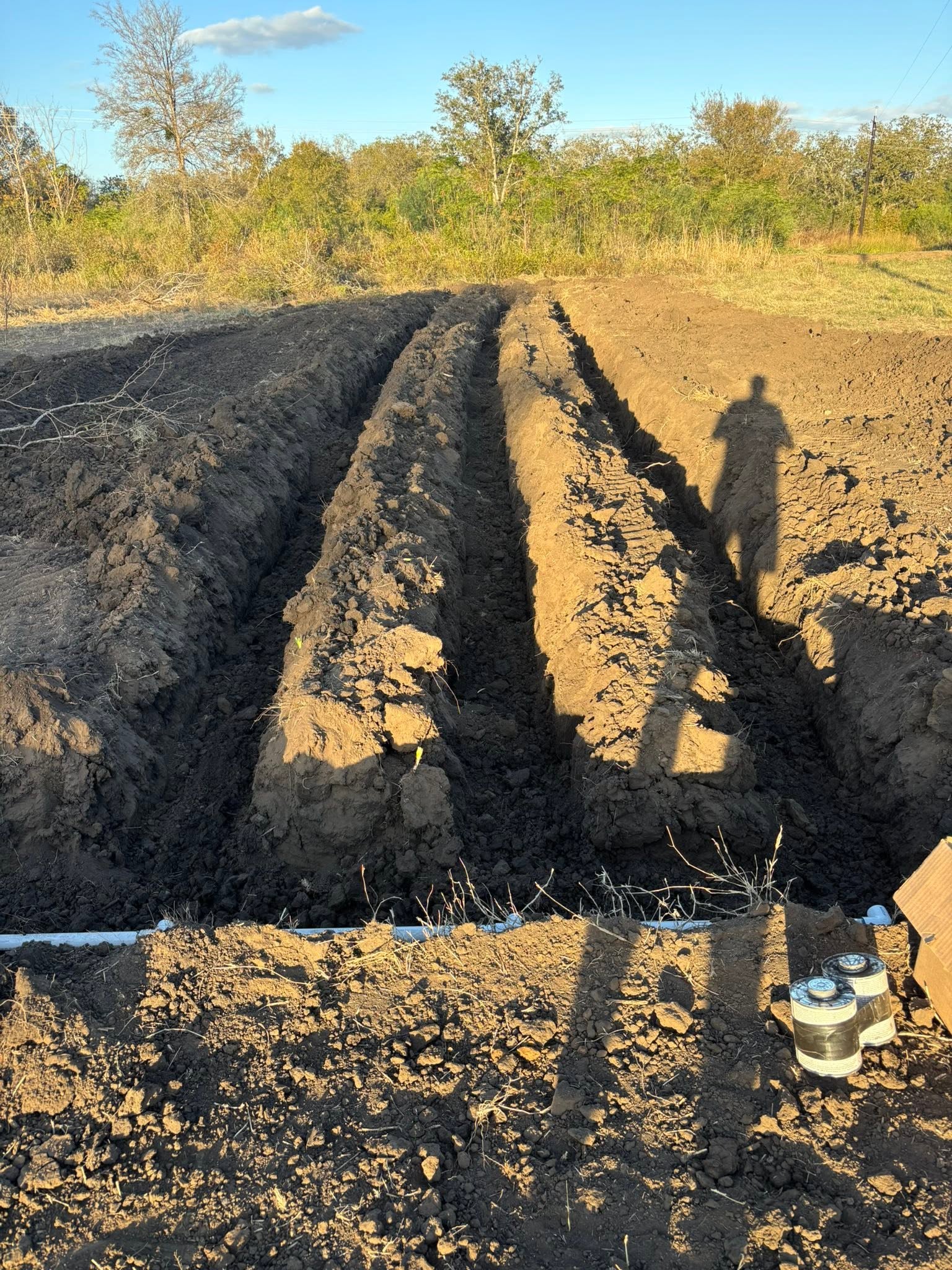 Parallel excavation trenches with pipe